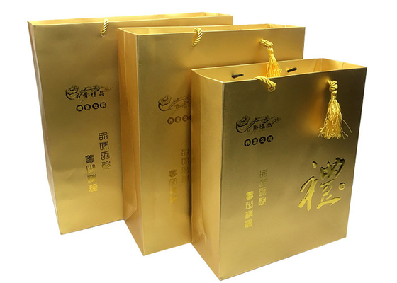 comprar Bolsos impresos de lujo de encargo del regalo del papel del oro con las manijas grabadas en relieve de Logo Tassel online manufacture
